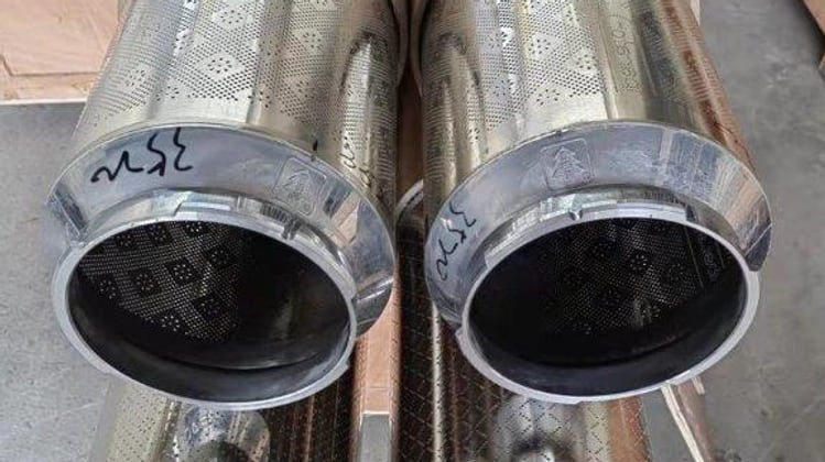 Open ends of nickel rotary screens showing the mesh perforation and the marked circumference