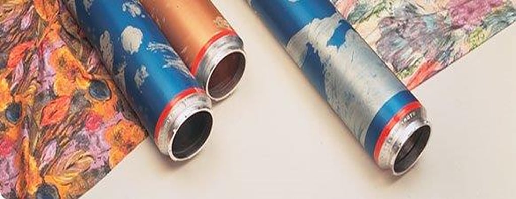 Engraved rotary screens beside the fabric printed with them