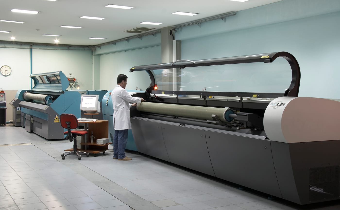 Laser engraving hall with machines in a row and technicians at work