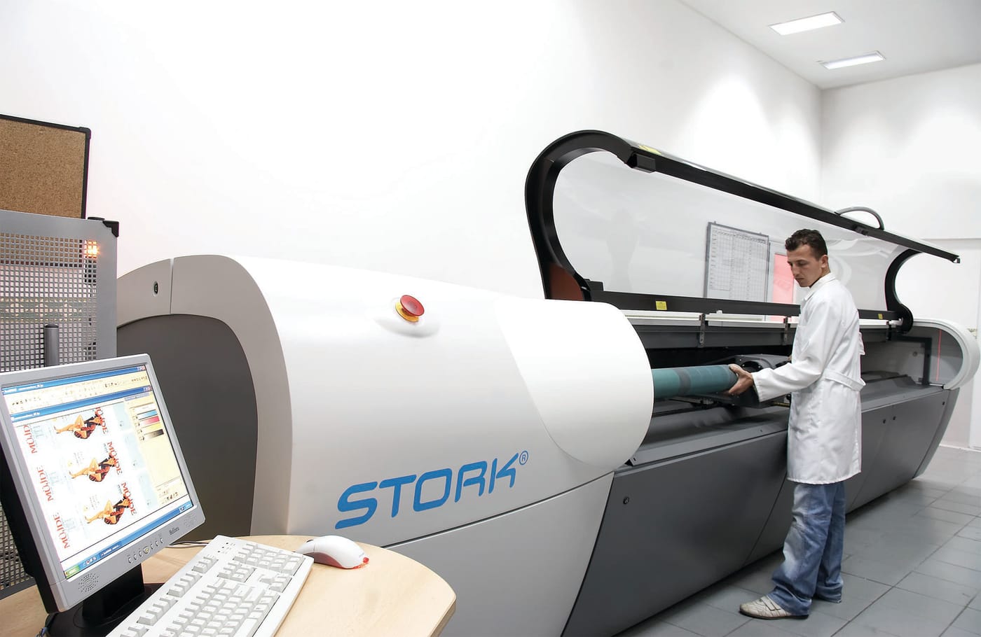 Operator at the control screen while a cylinder is engraved