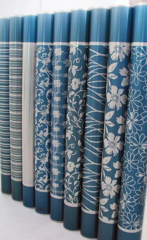 Rotary printing screens engraved with different designs side by side: stripes, damask, florals and solid grounds